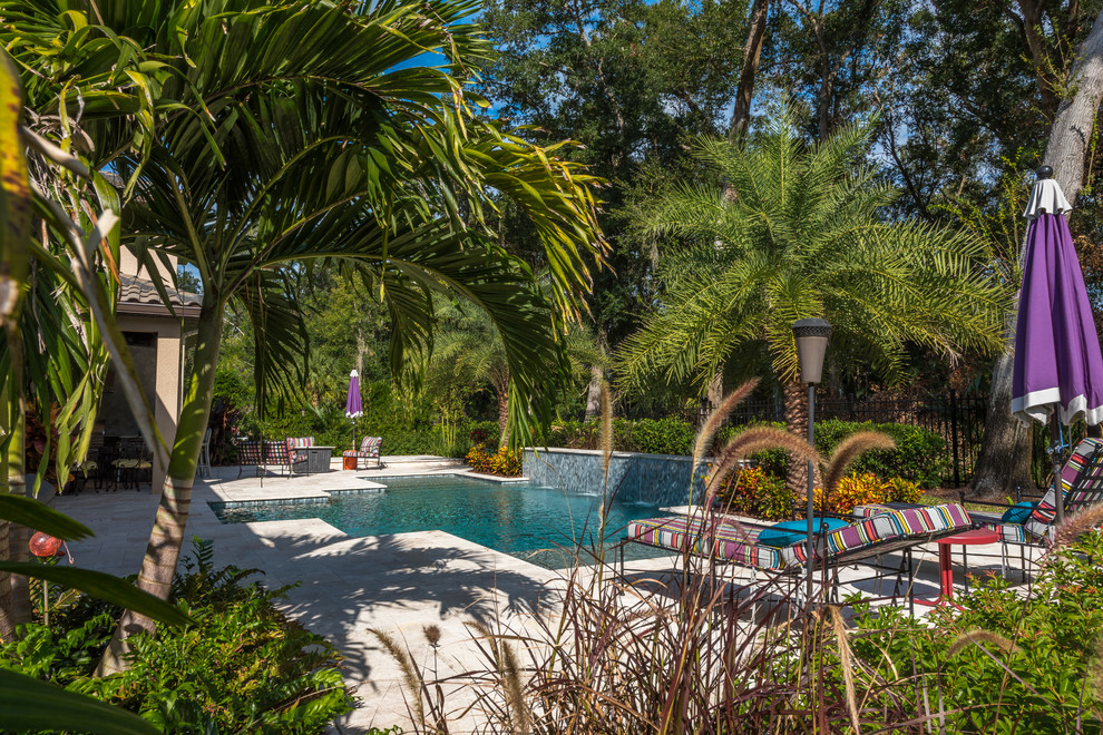 Inspiration for a medium sized world-inspired back custom shaped swimming pool in Orlando with concrete slabs.