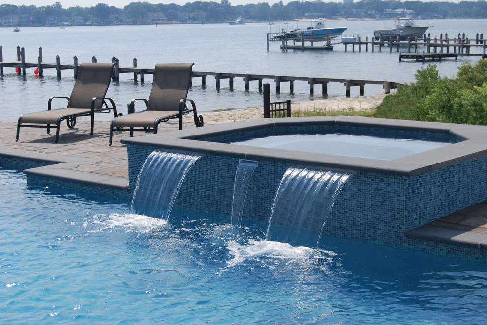 Design ideas for a modern swimming pool in New York with a water feature.
