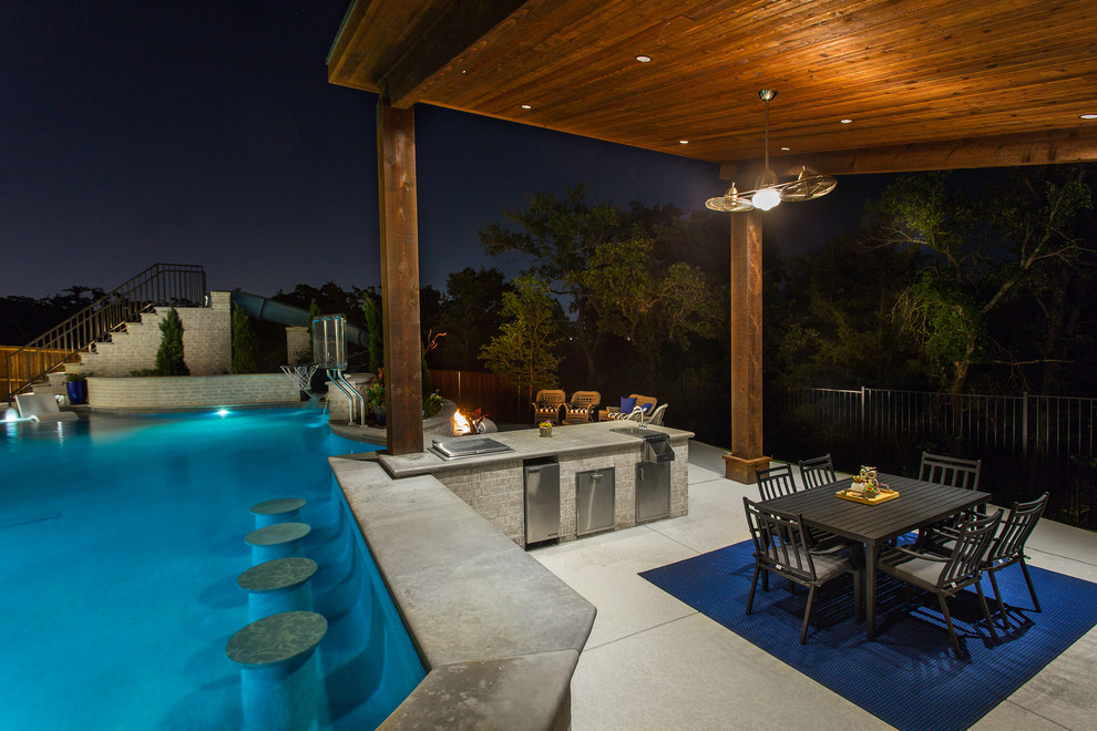 Example of a large transitional backyard concrete and custom-shaped natural water slide design in Dallas
