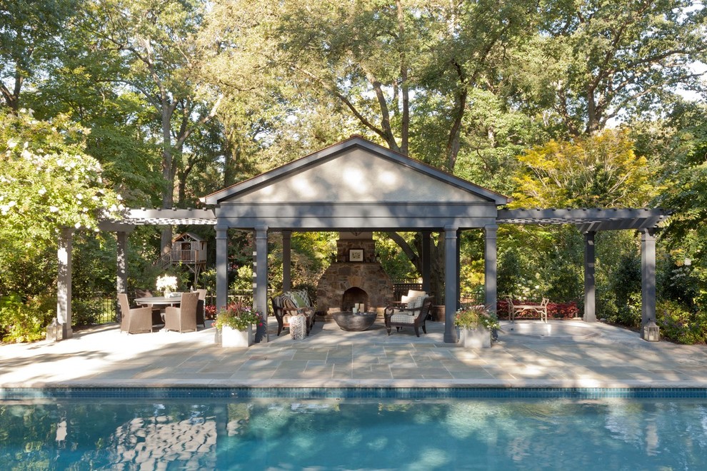Idee per una grande piscina monocorsia stile americano rettangolare dietro casa con pavimentazioni in pietra naturale