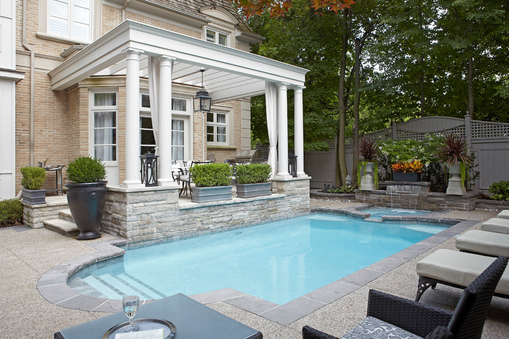 Photo of a medium sized classic back rectangular lengths hot tub in Toronto with concrete paving.