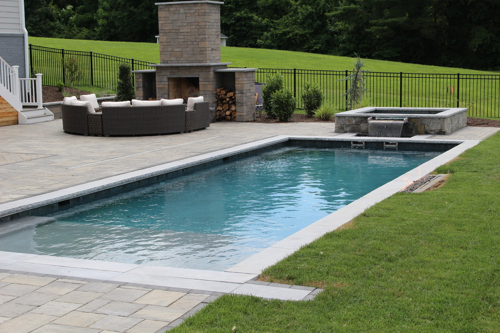 Inspiration for a medium sized modern back rectangular lengths hot tub in DC Metro with concrete paving.