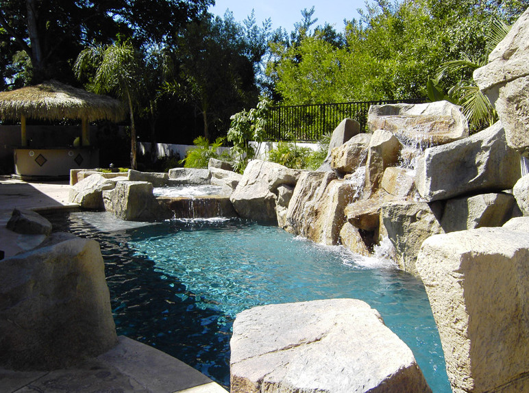 Pool fountain - tropical custom-shaped aboveground pool fountain idea in Orange County