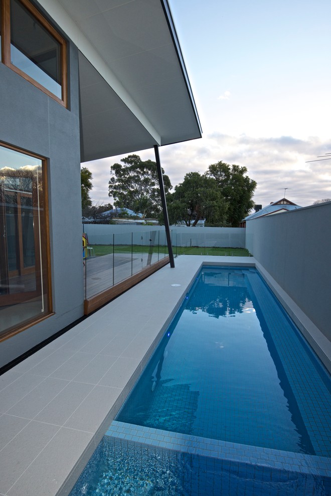 Example of a mid-sized minimalist side yard tile and rectangular lap hot tub design in Adelaide