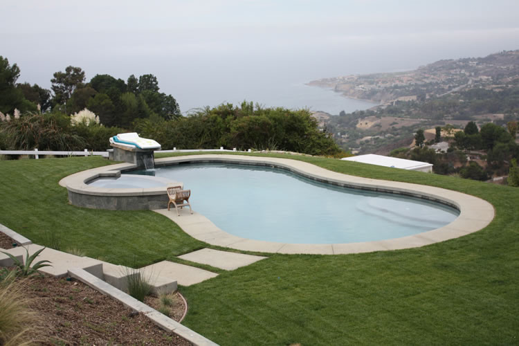 Design ideas for a large classic back custom shaped hot tub in Los Angeles with stamped concrete.