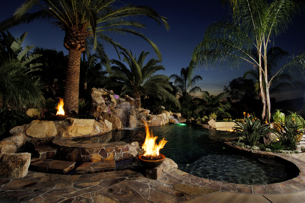 Inspiration for a huge backyard concrete paver and custom-shaped pool fountain remodel in San Diego