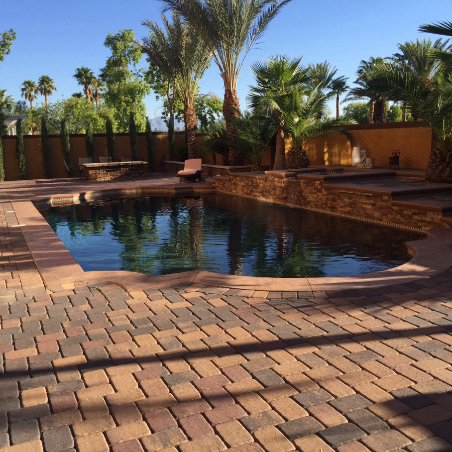 Inspiration for a medium sized traditional back custom shaped lengths swimming pool in Las Vegas with brick paving.