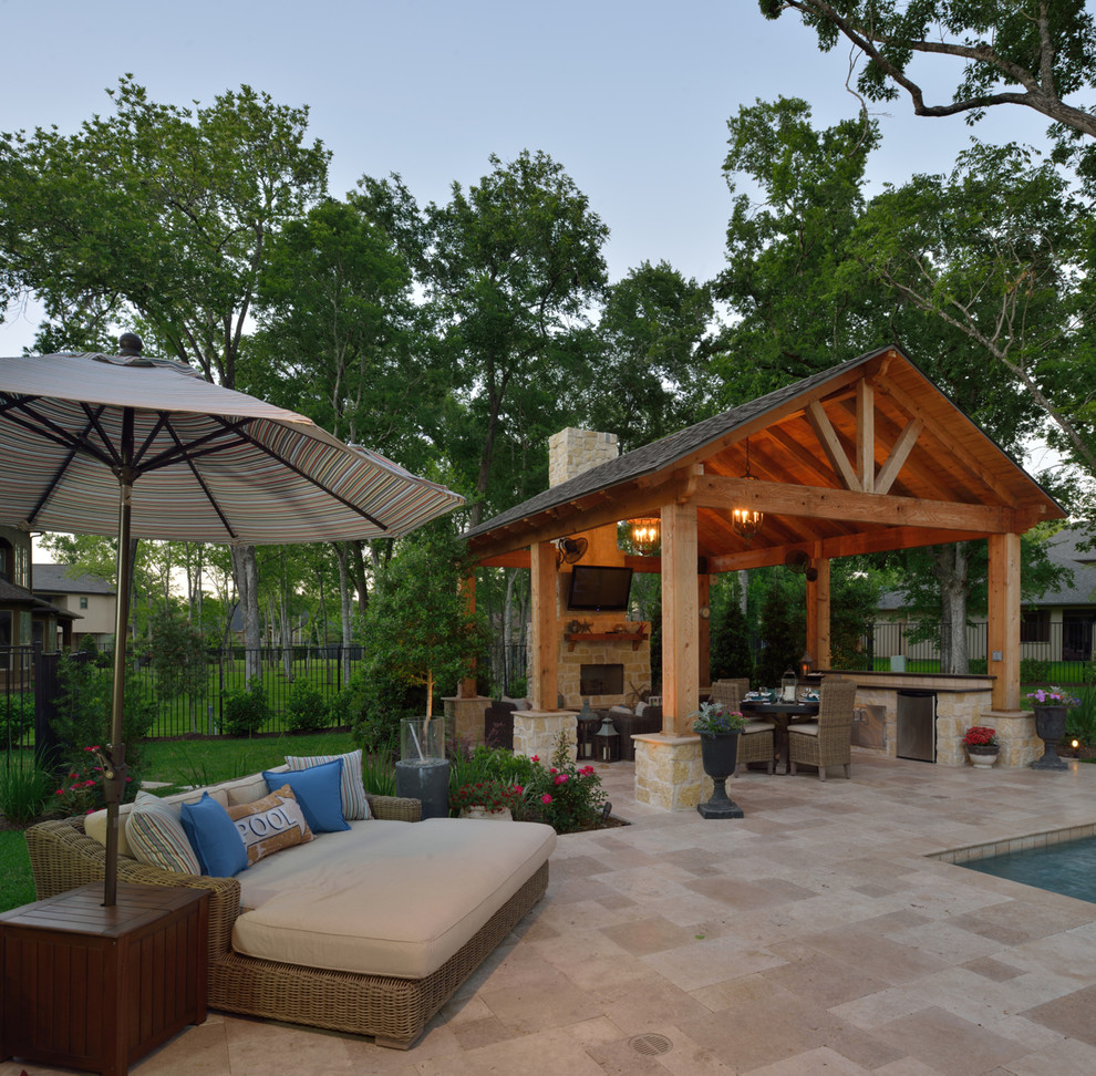 Large elegant backyard stone patio photo in Dallas