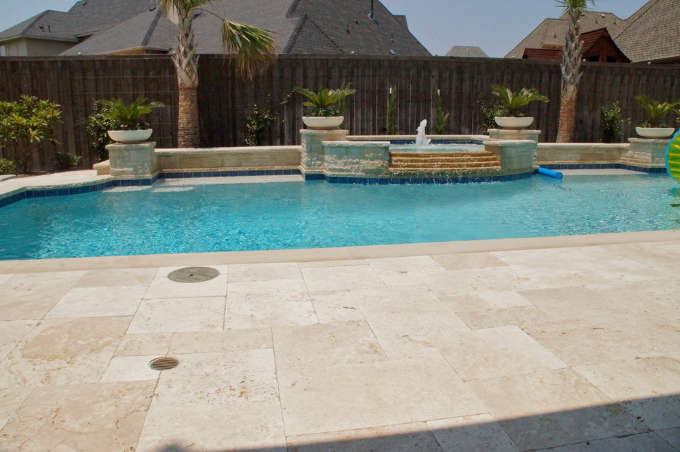 Pool fountain - large traditional backyard stone and rectangular lap pool fountain idea in Dallas