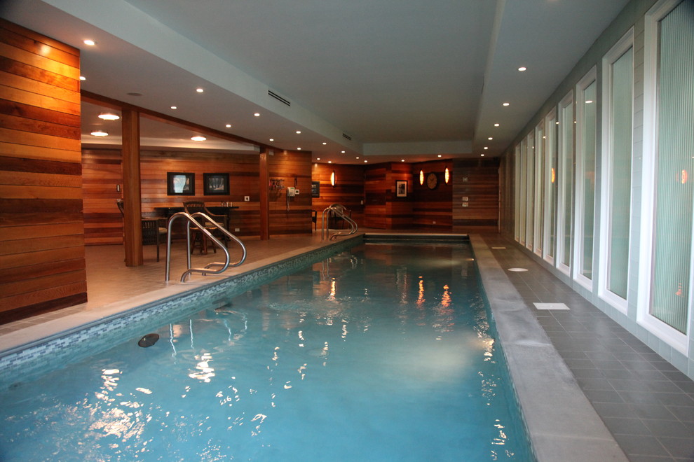 This is an example of a large contemporary indoor rectangular lengths swimming pool in New York with tiled flooring.