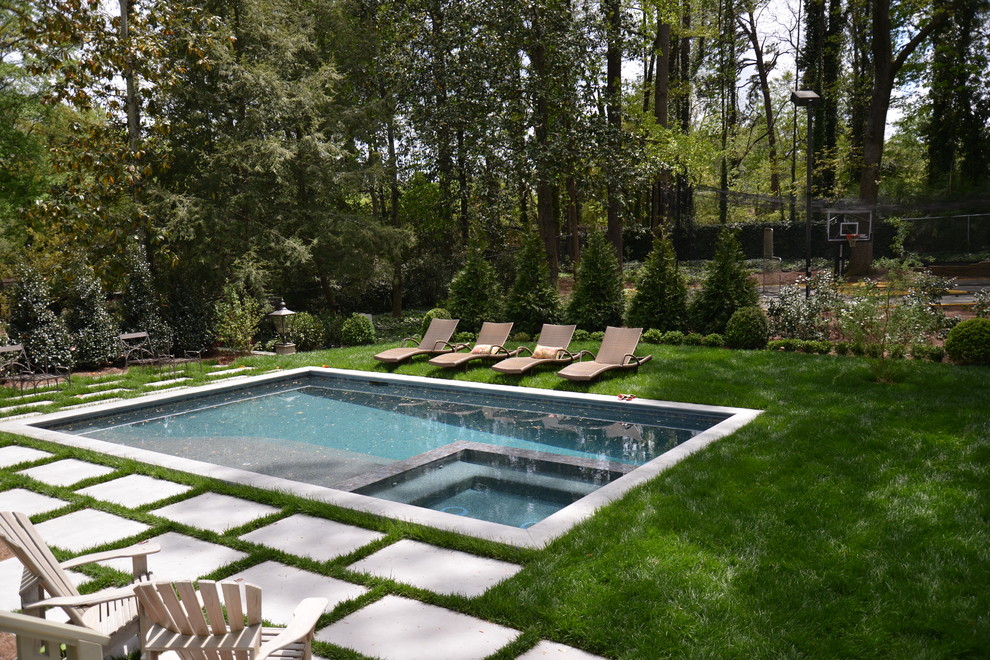 Inspiration for a contemporary back swimming pool in Atlanta with concrete paving.
