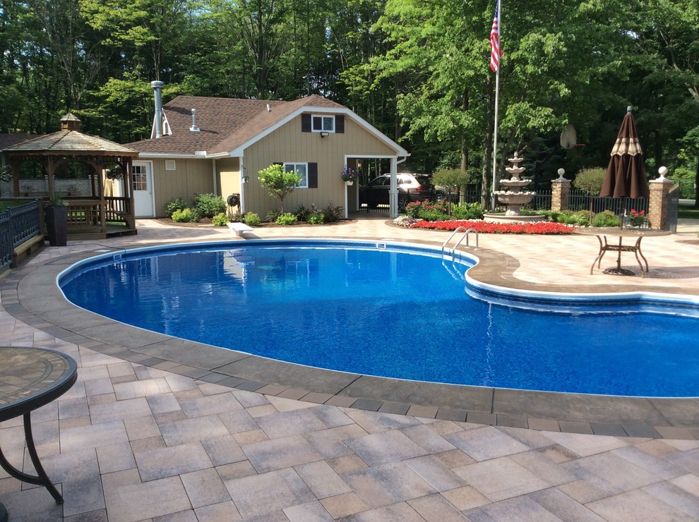 Inspiration for a mid-sized contemporary backyard stone and kidney-shaped pool remodel in Cleveland