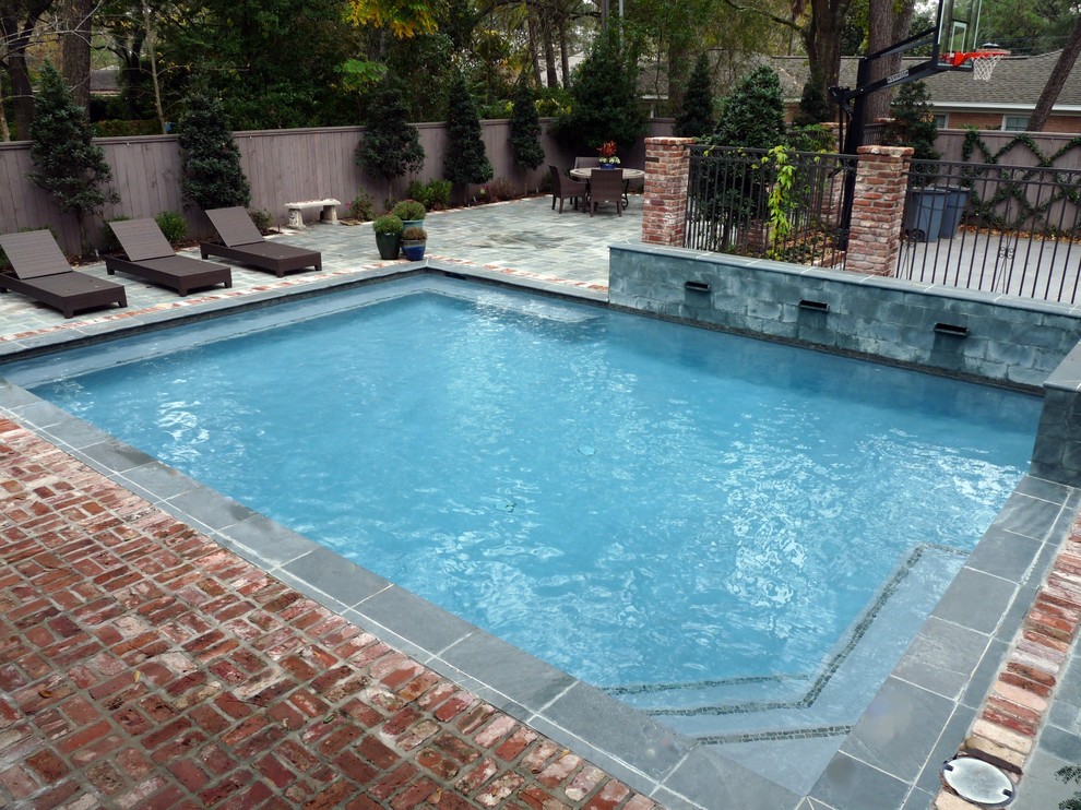Design ideas for a medium sized back rectangular lengths swimming pool in Houston with a water feature and brick paving.