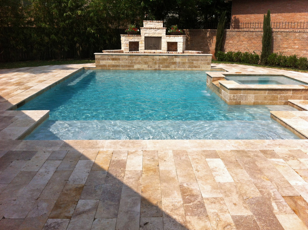 Mid-sized tuscan backyard stone and custom-shaped hot tub photo in Houston