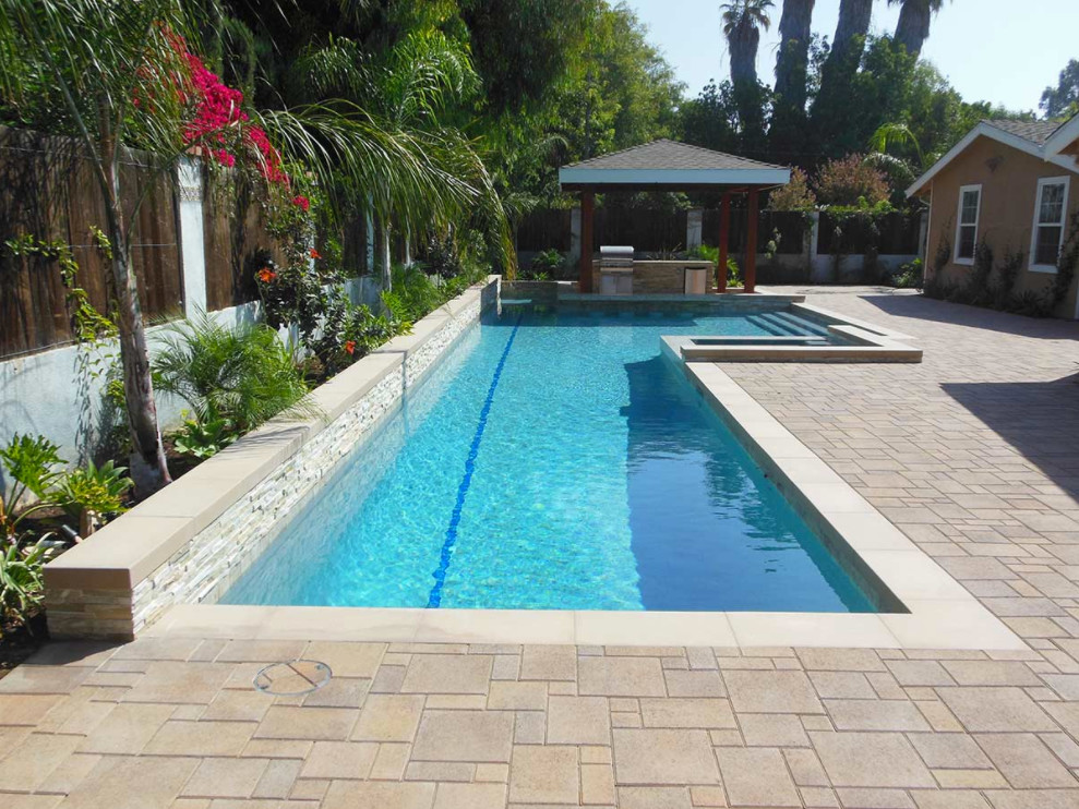 Example of a mid-sized tuscan backyard concrete and rectangular natural hot tub design in Orange County