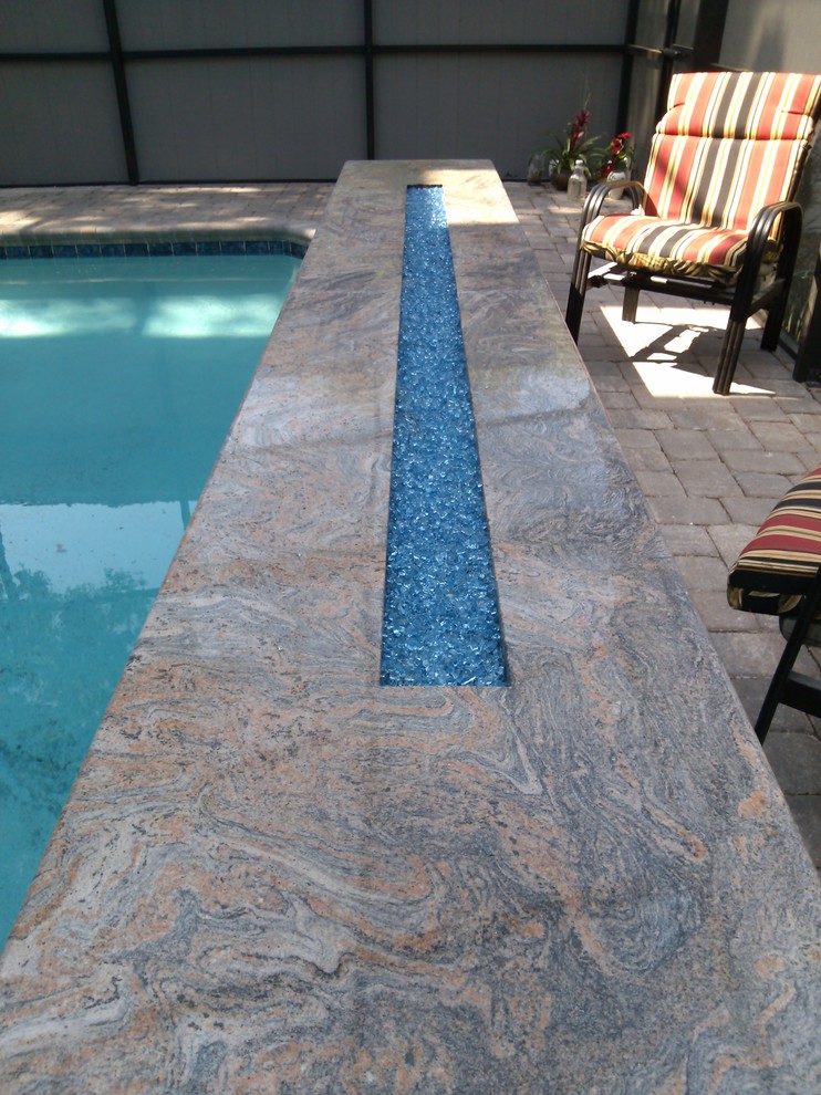 Design ideas for a contemporary swimming pool in Tampa.