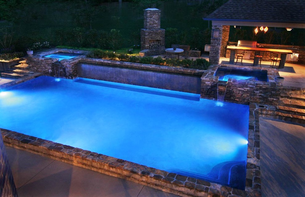 Hot tub - large mediterranean backyard stone and rectangular lap hot tub idea in Houston