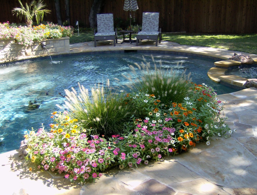 Mid-sized island style backyard stone and custom-shaped lap hot tub photo in Dallas
