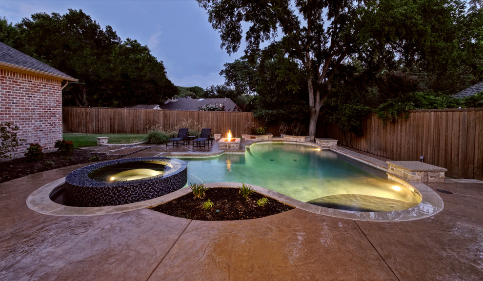 Inspiration for a mid-sized contemporary backyard stamped concrete and custom-shaped lap hot tub remodel in Dallas