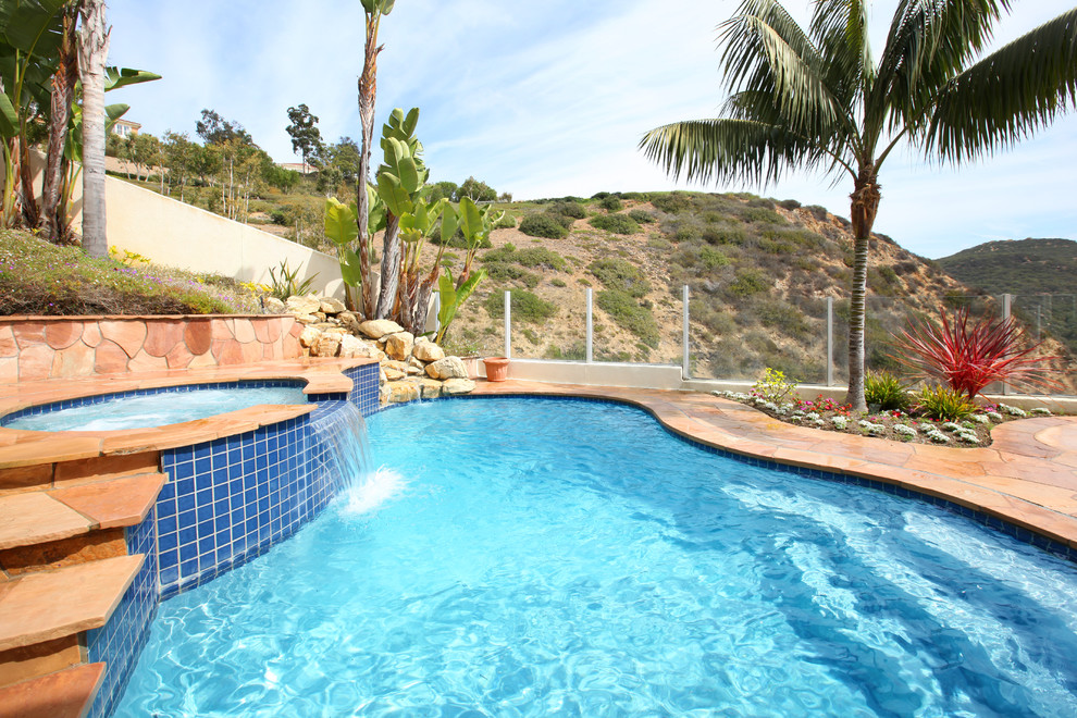 Island style custom-shaped pool photo in Orange County