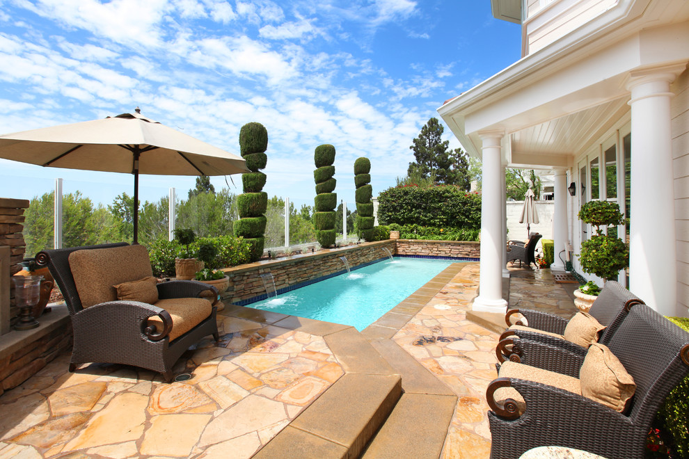 Elegant rectangular pool photo in Orange County