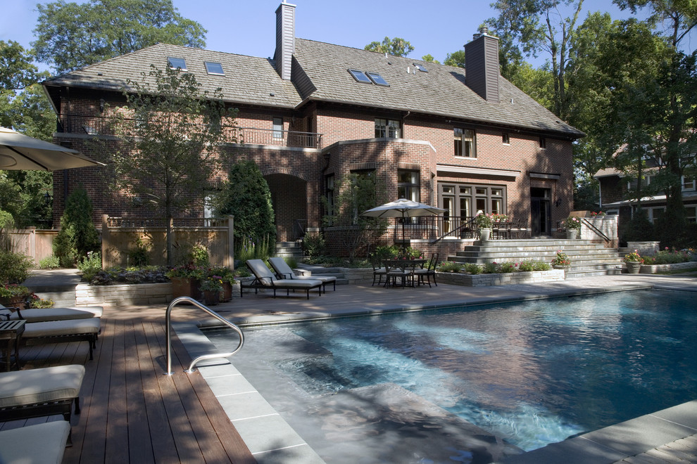 Pool - traditional backyard pool idea in Chicago with decking