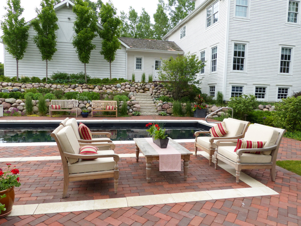 Poolside seating arrangement with brick area rug - Farmhouse - Pool ...