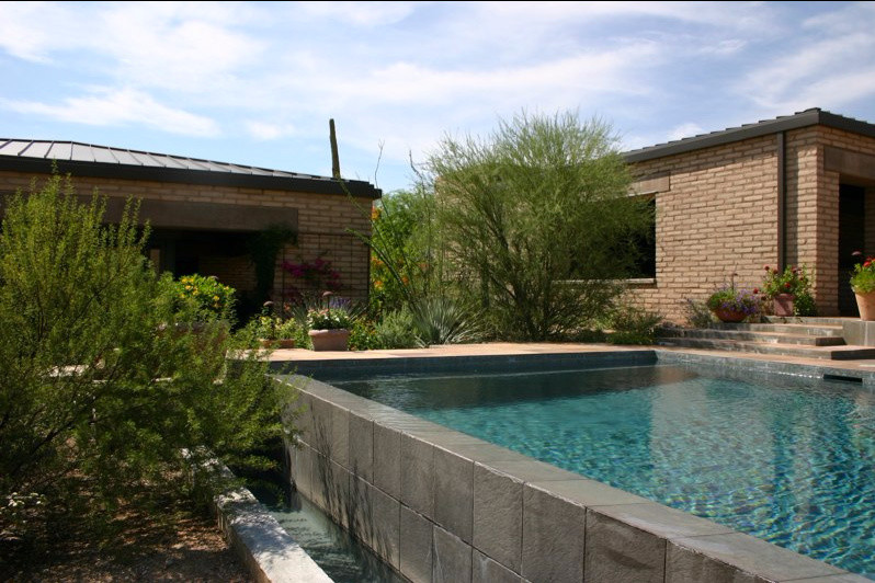 Aménagement d'une piscine hors-sol et arrière craftsman de taille moyenne et rectangle avec des pavés en béton.