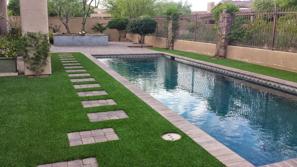 Example of a mid-sized transitional backyard brick and rectangular lap pool design in San Diego