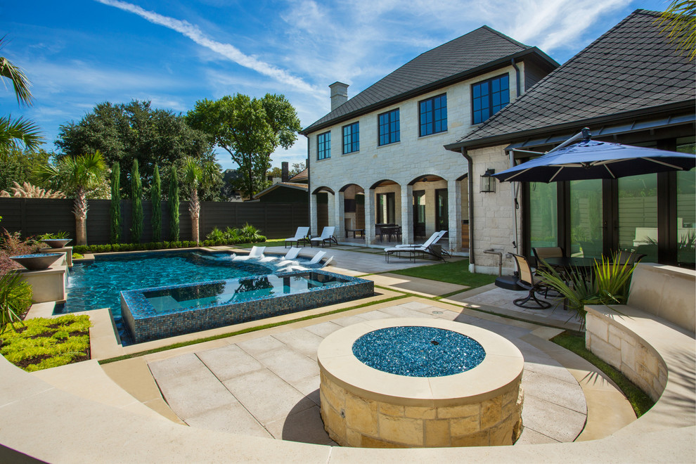 Diseño de piscina clásica renovada grande a medida en patio trasero con adoquines de piedra natural