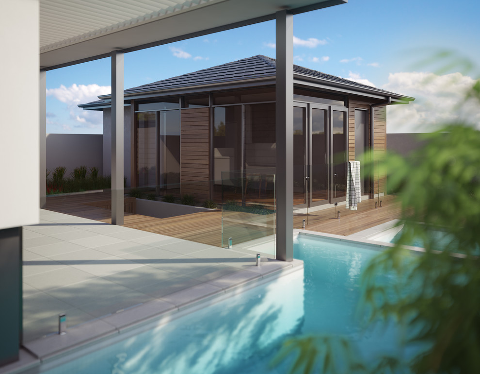 Ispirazione per una piscina monocorsia design a "L" di medie dimensioni e dietro casa con piastrelle e una vasca idromassaggio