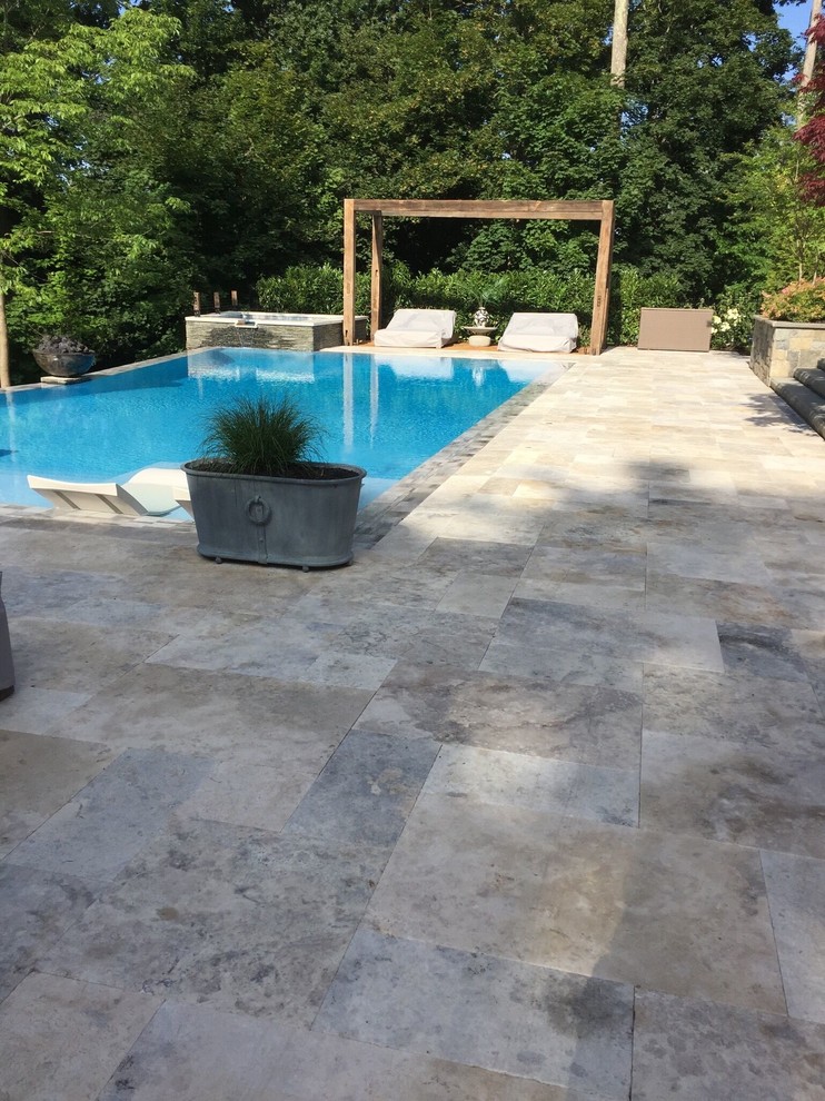 Example of a large backyard stone and rectangular lap hot tub design in New York