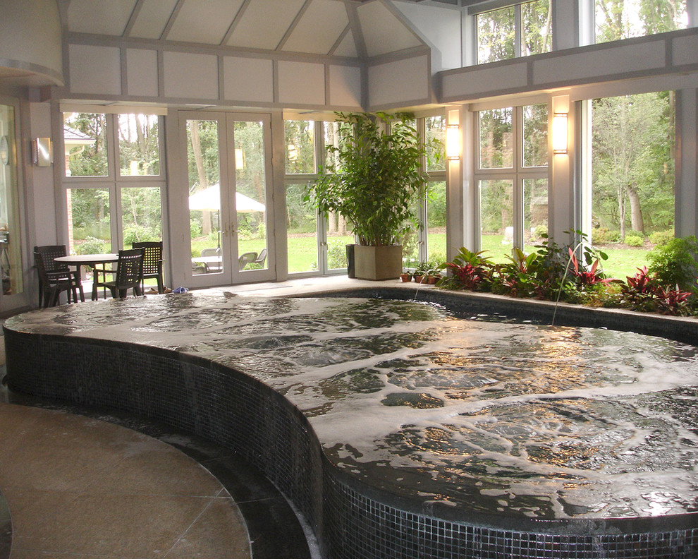 Modelo de piscinas y jacuzzis infinitos actuales grandes interiores y tipo riñón con adoquines de piedra natural