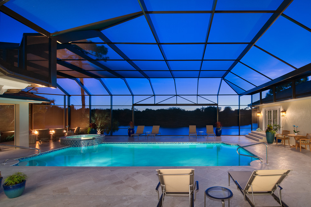 Immagine di una piscina stile marinaro rettangolare di medie dimensioni e dietro casa con pavimentazioni in pietra naturale