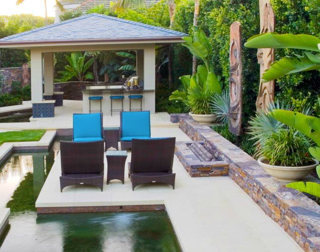 Photo of a large world-inspired back rectangular lengths swimming pool in Orange County with a pool house and concrete paving.