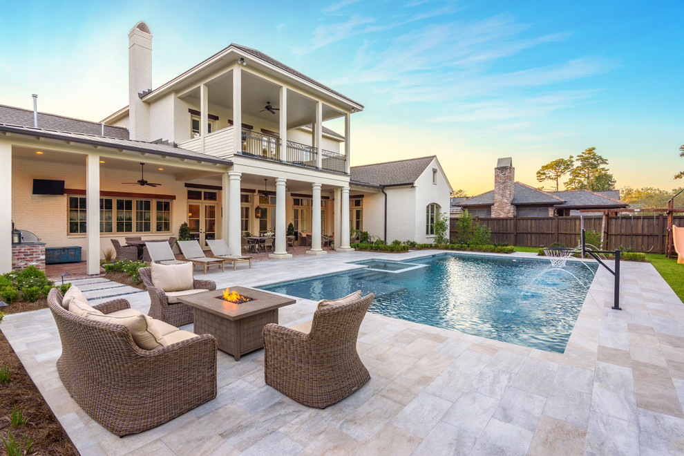 Elegant tile and rectangular pool photo in New Orleans