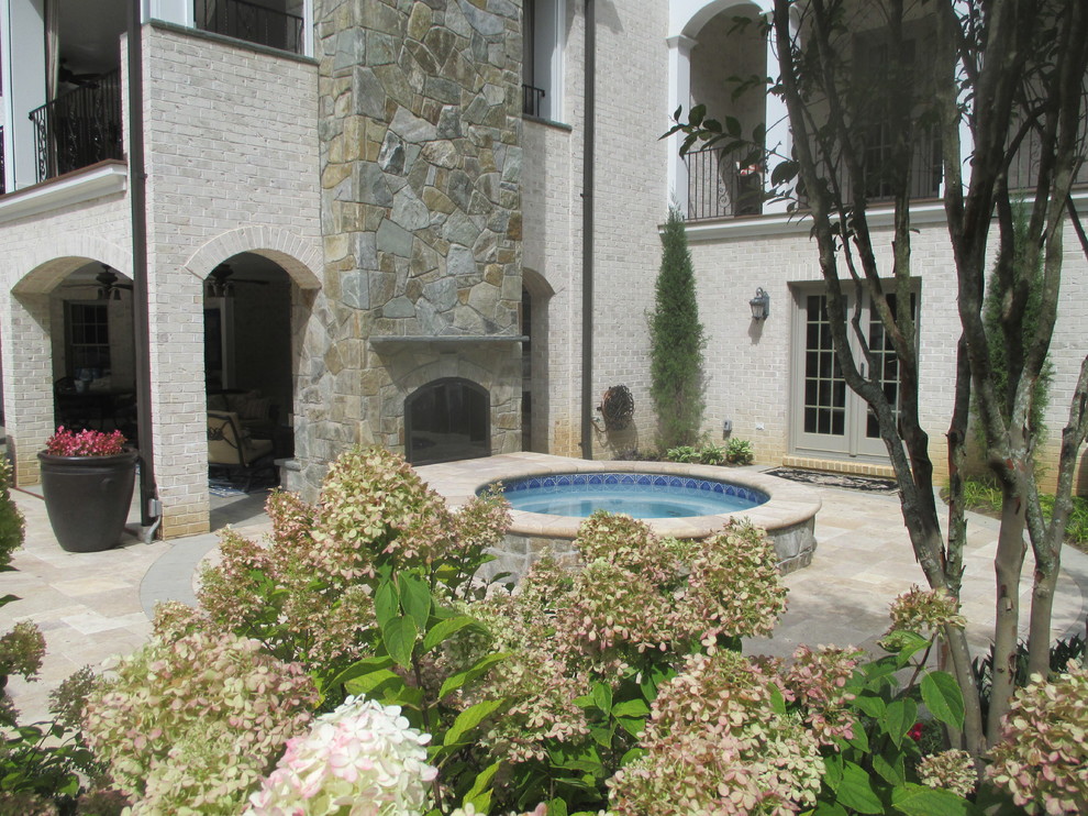 Idéer för en stor medelhavsstil pool på baksidan av huset, med spabad och naturstensplattor
