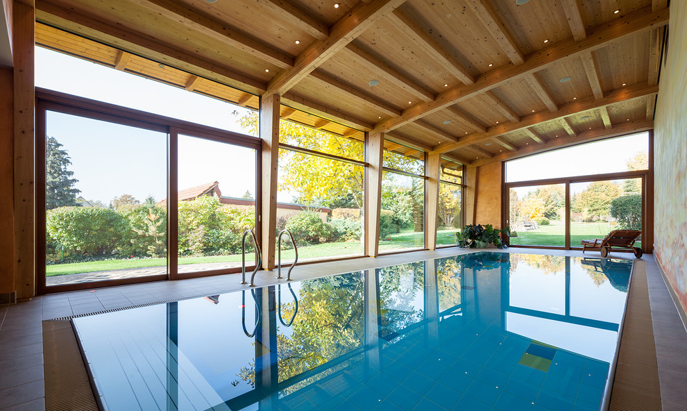 This is an example of a medium sized rustic indoor rectangular swimming pool in Leipzig.