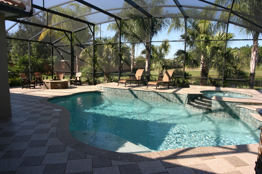 Large island style indoor concrete paver and custom-shaped lap hot tub photo in Orlando