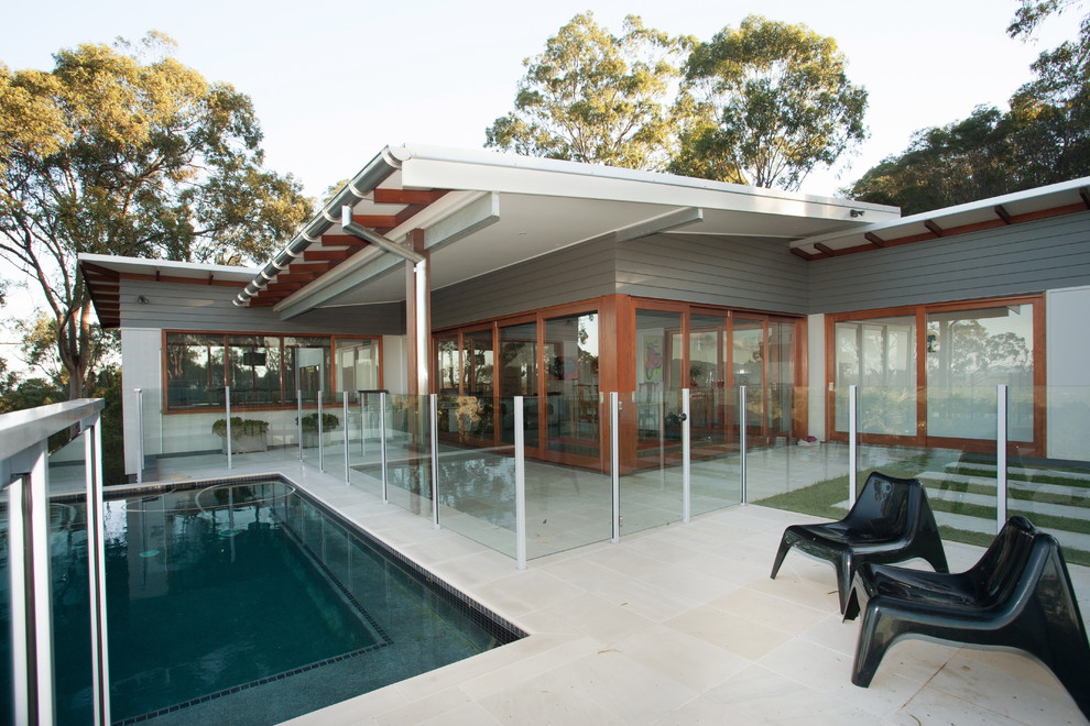 Pool - mid-sized contemporary stone and rectangular infinity pool idea in Brisbane
