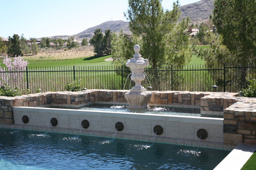 Example of a large tuscan backyard custom-shaped pool fountain design in Las Vegas