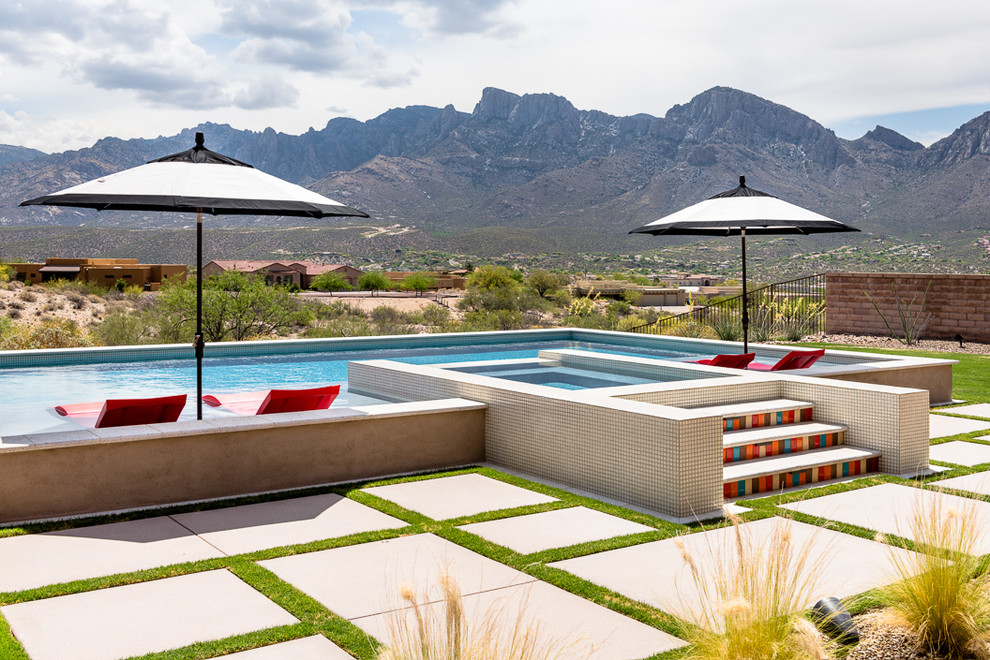 Diseño de piscinas y jacuzzis elevados de estilo americano de tamaño medio rectangulares en patio trasero con suelo de baldosas