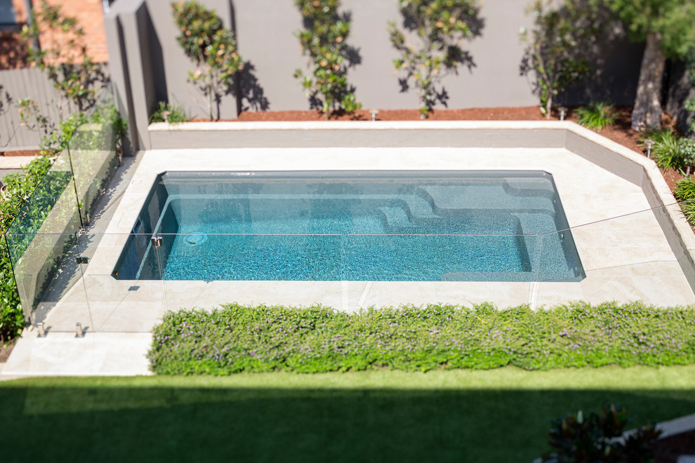 Mid-sized trendy backyard stone and rectangular lap pool photo in Sydney
