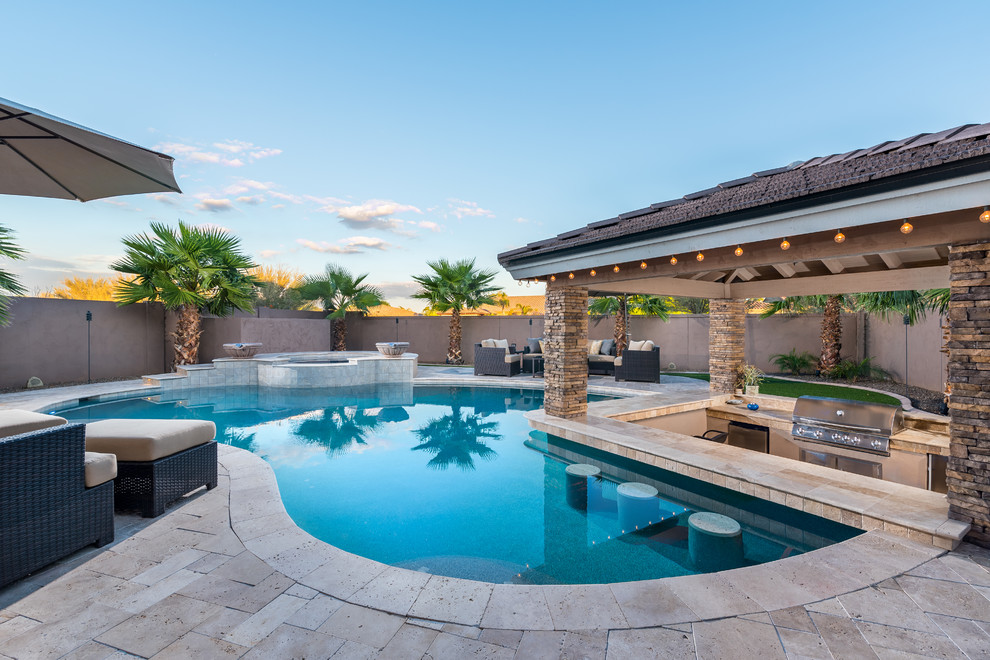 Inspiration for a large contemporary back custom shaped hot tub in Phoenix with natural stone paving.