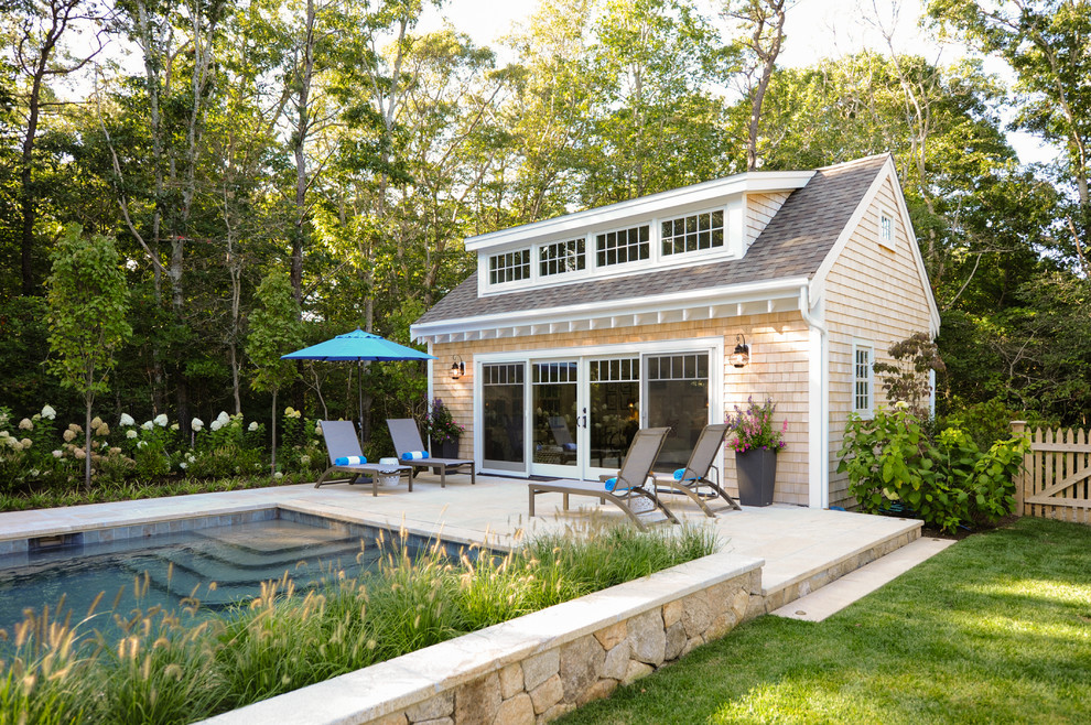 Pool house - coastal backyard stone and rectangular pool house idea in Boston