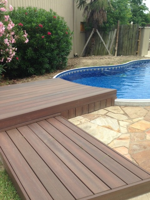 Cette image montre une petite piscine arrière traditionnelle en forme de haricot avec une terrasse en bois.