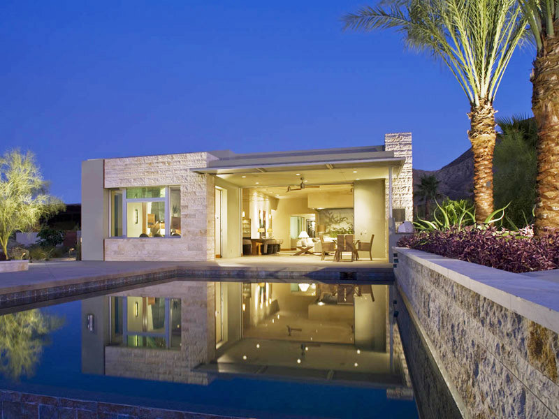 Medium sized modern back rectangular natural swimming pool in Orange County with a pool house and concrete paving.