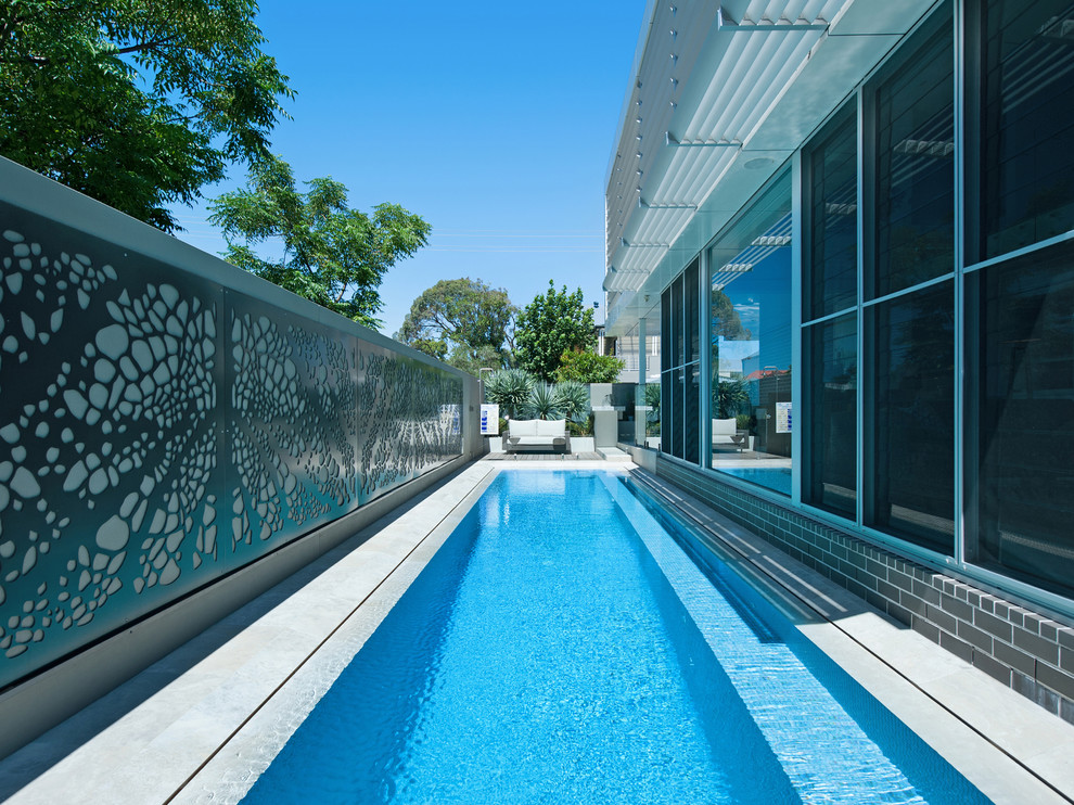 Contemporary side rectangular lengths swimming pool in Newcastle - Maitland with tiled flooring.