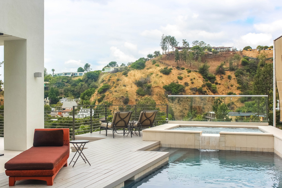 Inspiration for a mid-sized modern backyard pool remodel in Los Angeles with decking