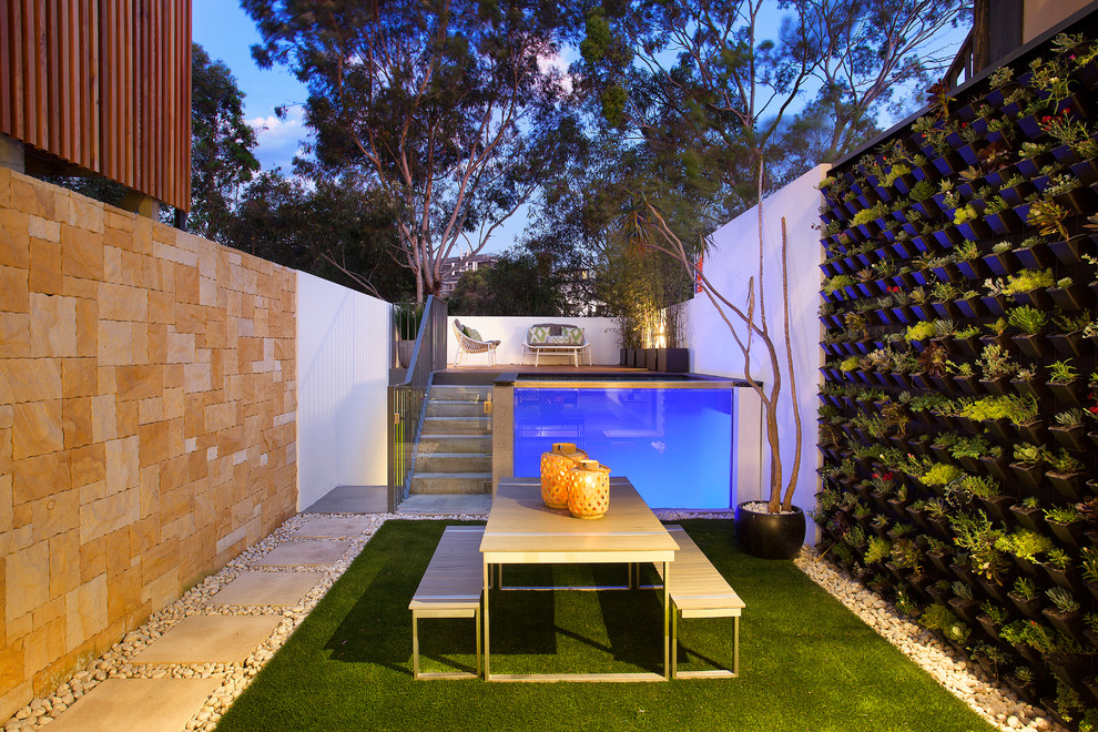 Inspiration for a modern back infinity swimming pool in Sydney with natural stone paving.